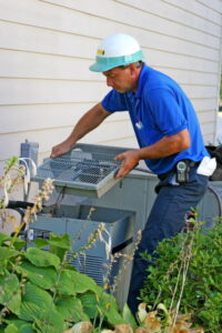 technician-opening-the-outdoor-unit-of-an-air-conditioner-to-access-the-compressor